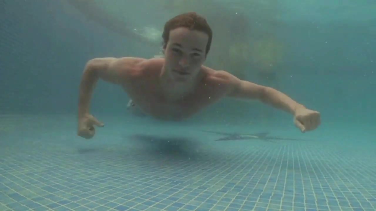 Underwater barefaced fit guys in pool