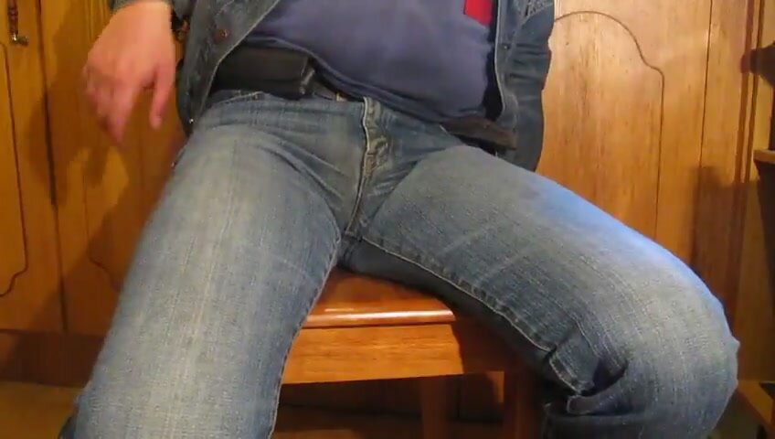 Cuffed guy pees jeans on a chair
