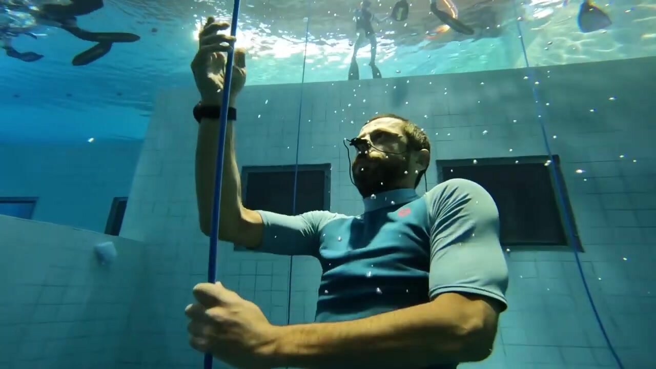 Underwater barefaced french freediver in pool