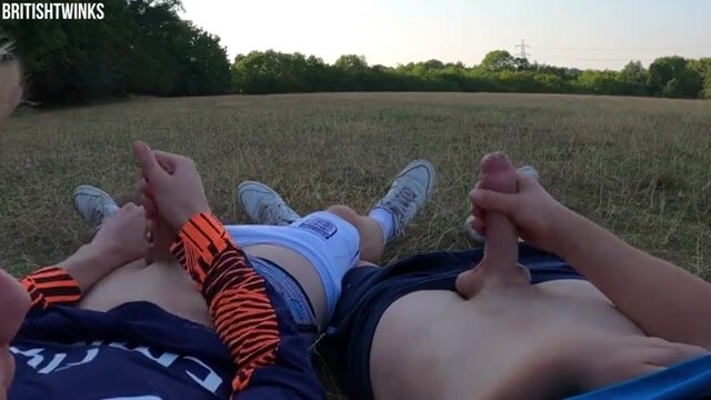 Two British twinks wanking off together in park