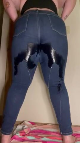 Woman wetting jeans from behind.