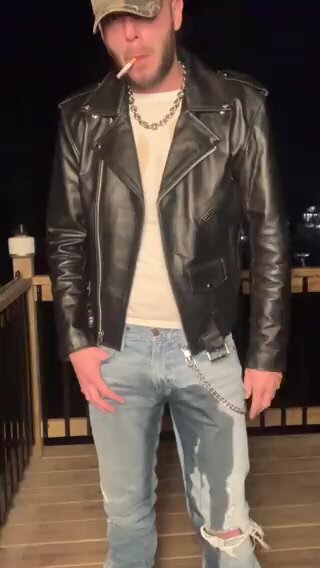 Redneck in leather jacket pissing and smoking
