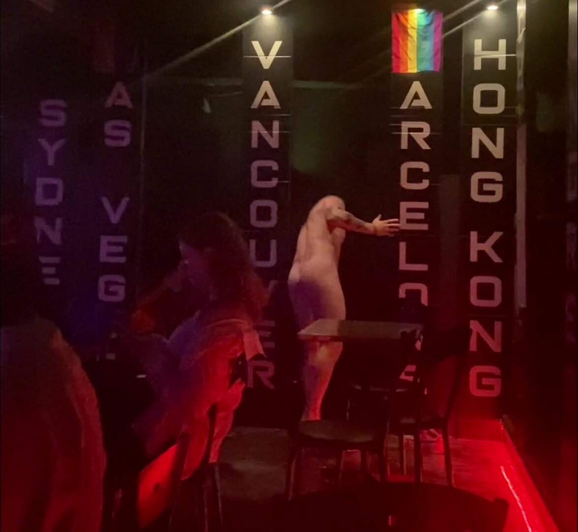 Cute stripper finishing a nude lapdance.