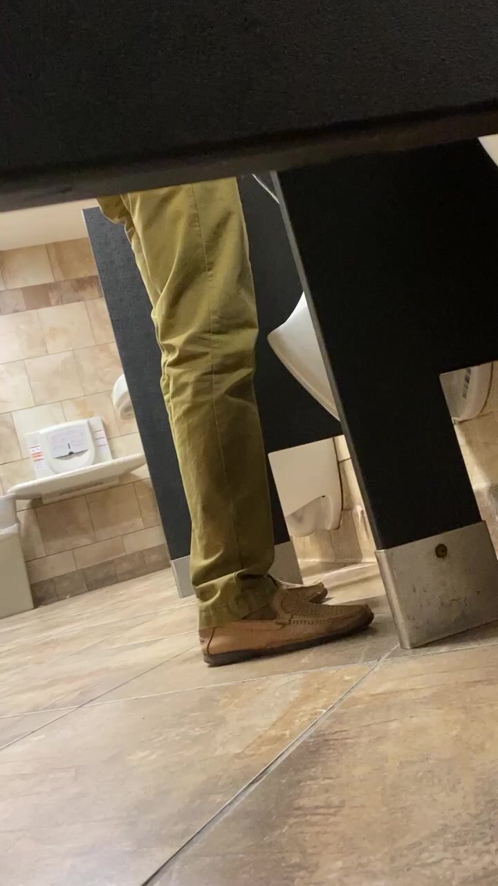 Blue collar Dude pisses at urinal