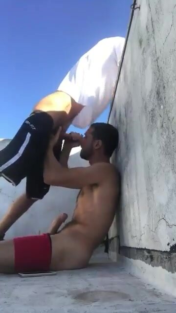 Sucking friend's cock on the roof