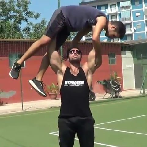 twink gets lifted overhead by muscle stud