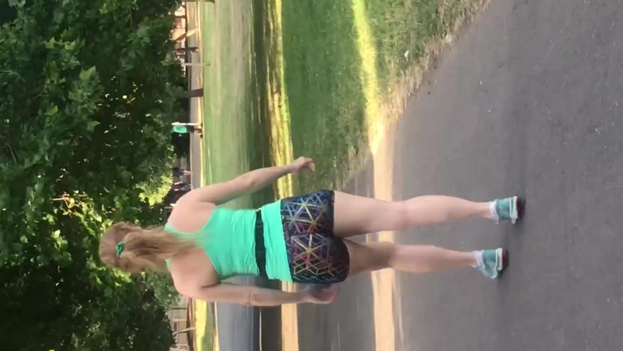 Sexy redhead walking in hotpants in the park