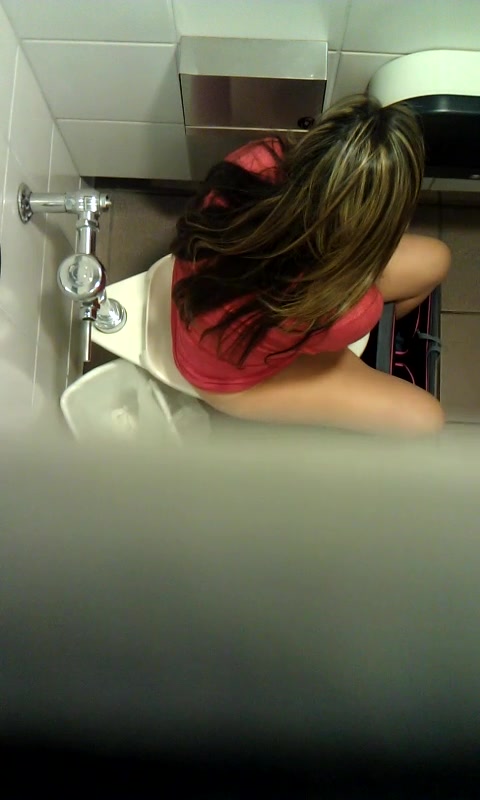 Woman peeing in public toilet