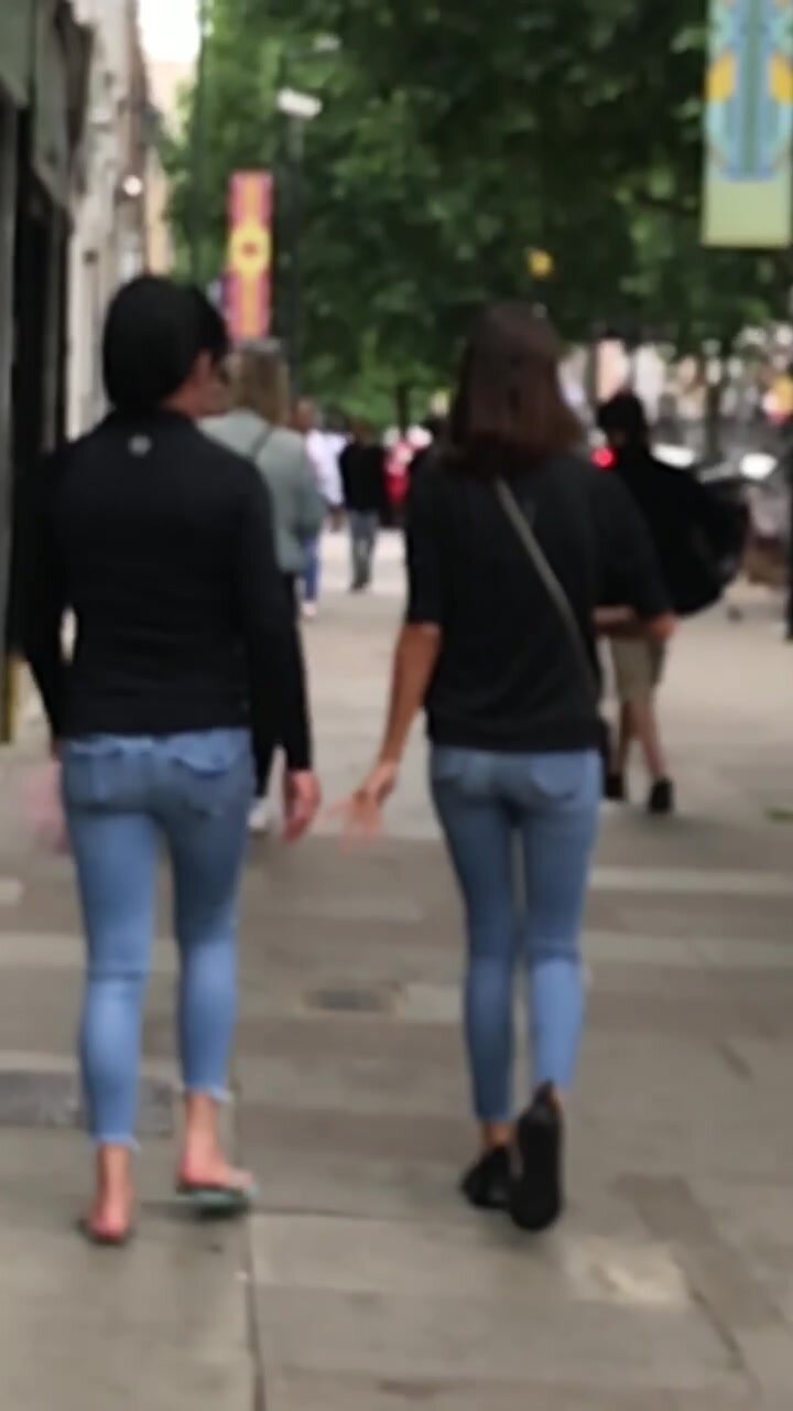 Two sexy brunettes walking in jeans
