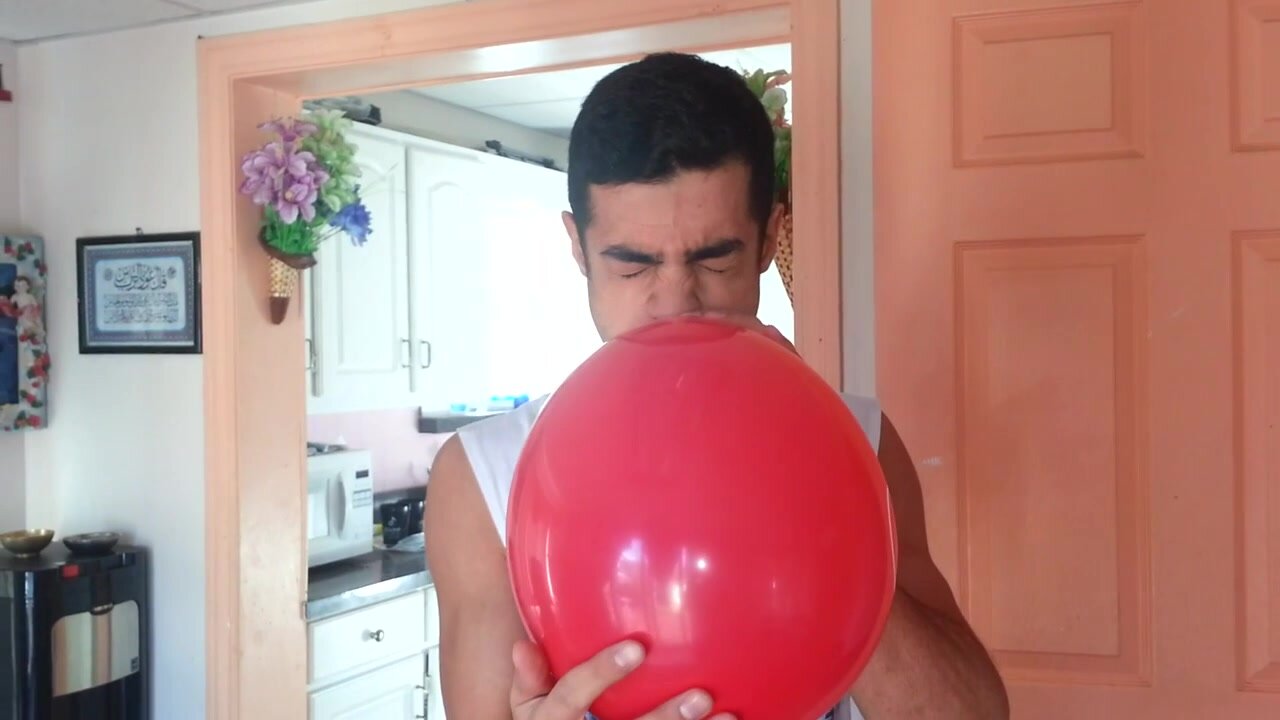 Young man blow balloon