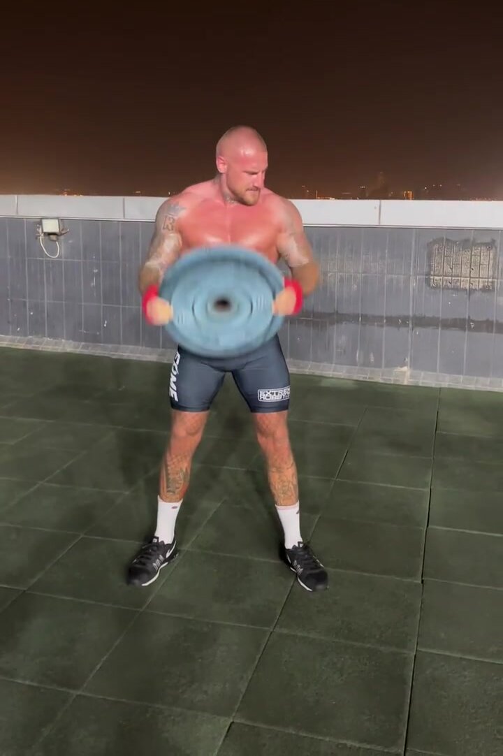 Hot muscle daddy trains on the roof of a skyscraper