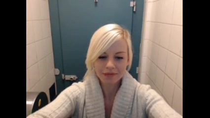Pretty blonde making a webcam video in a toilet