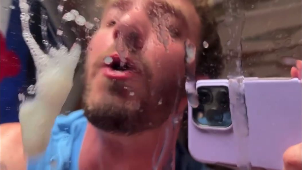 Guy spits on mirror, then lick it
