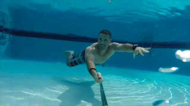Fit hunk swimming barefaced underwater