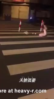 Asian woman masturbates at street crossing