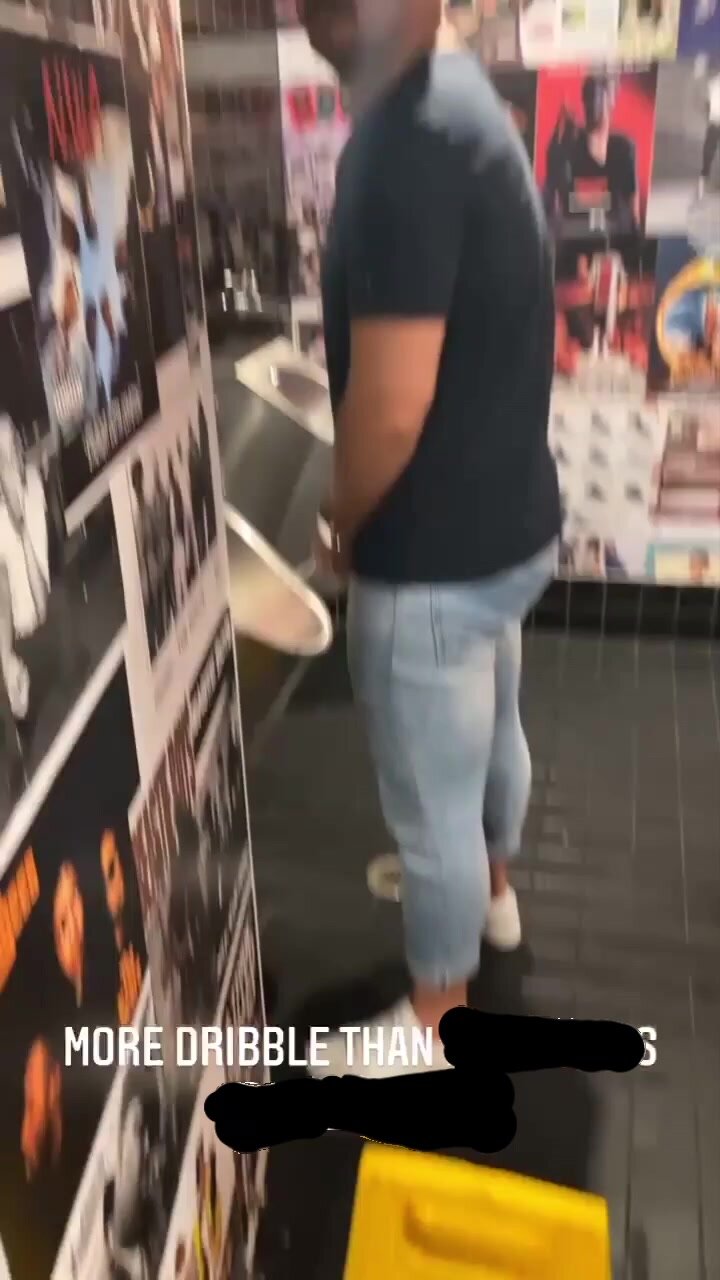 Filming his mate at the urinal