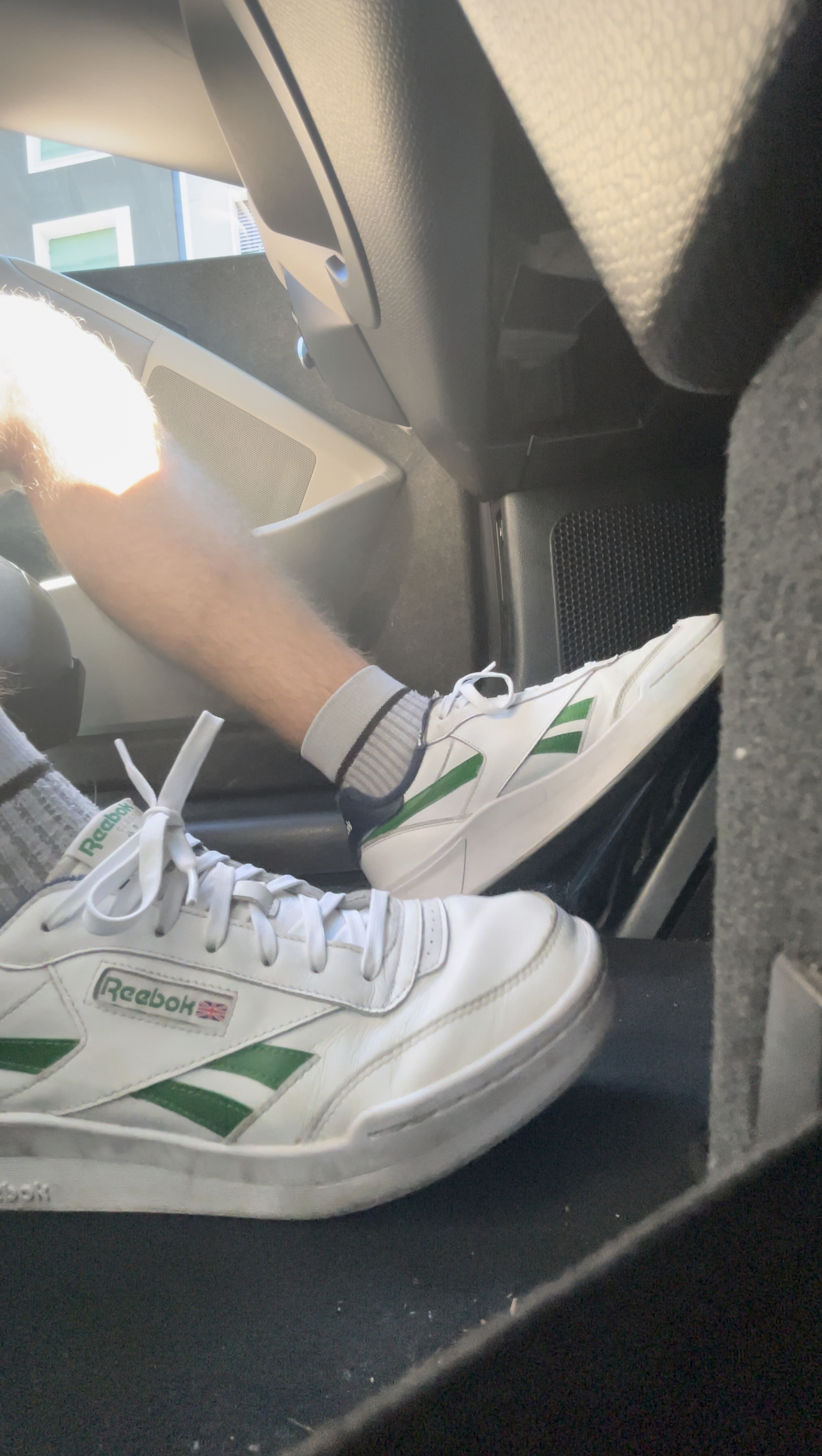 Young teen driving with REEBOK Club C Revenge Legacy