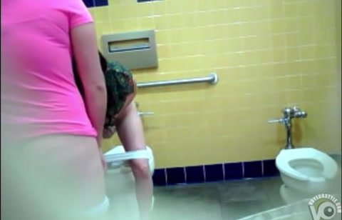 Two Latinas using public restroom