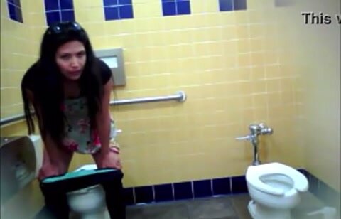 Latina peeing in public toilet