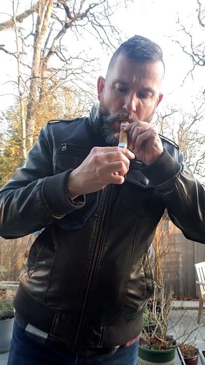 leather cigar stud lights up outdoors