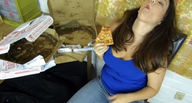 Girl stuffs her face with a ton of pizza
