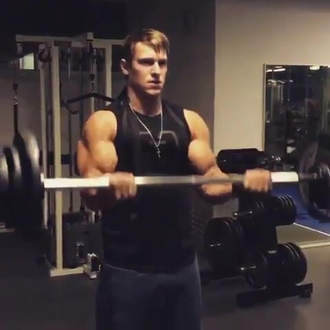 bodybuilder flexes his humongous biceps