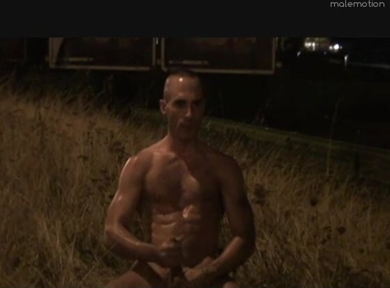 Hung, fit guy jerking next to road with facial