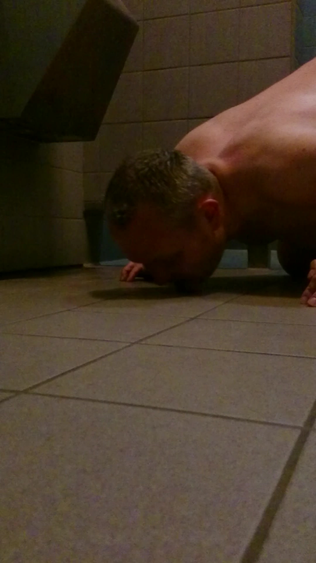 Me cleaning the floor in front of an public urinal
