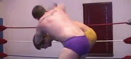 Smaller guy beating up  a tall wrestler