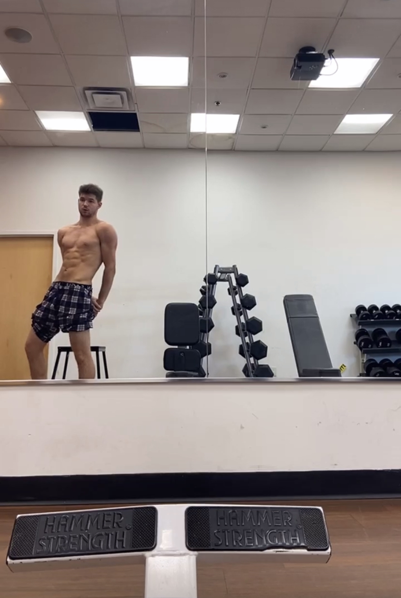 Cocky boy flexes after workout