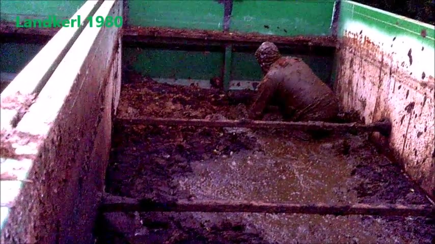 worker playing in slurry container