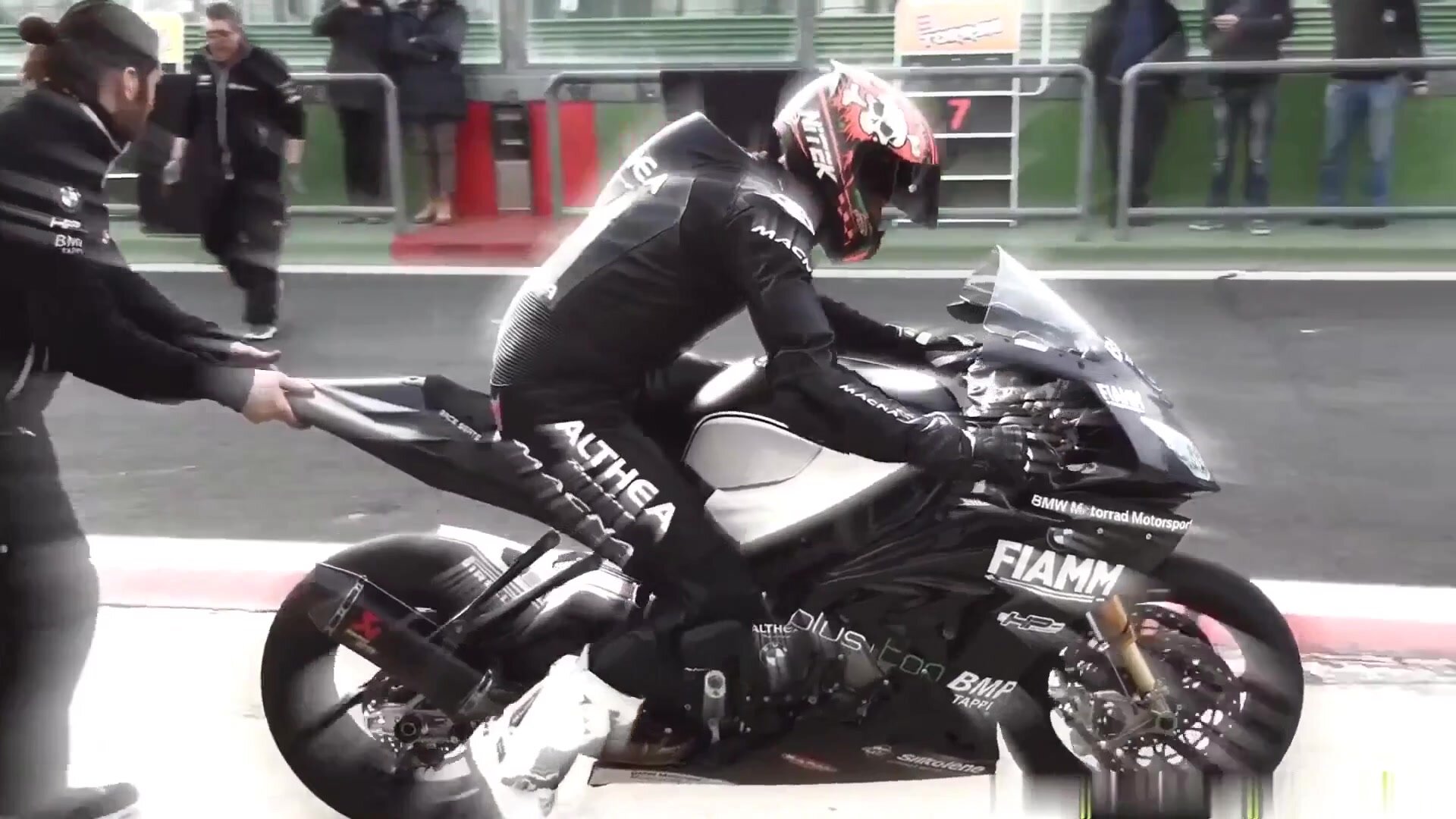Superbike rider in black leather racing suit