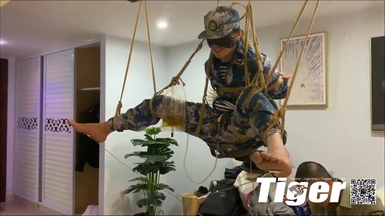 military guy suspended with feet electrotortured