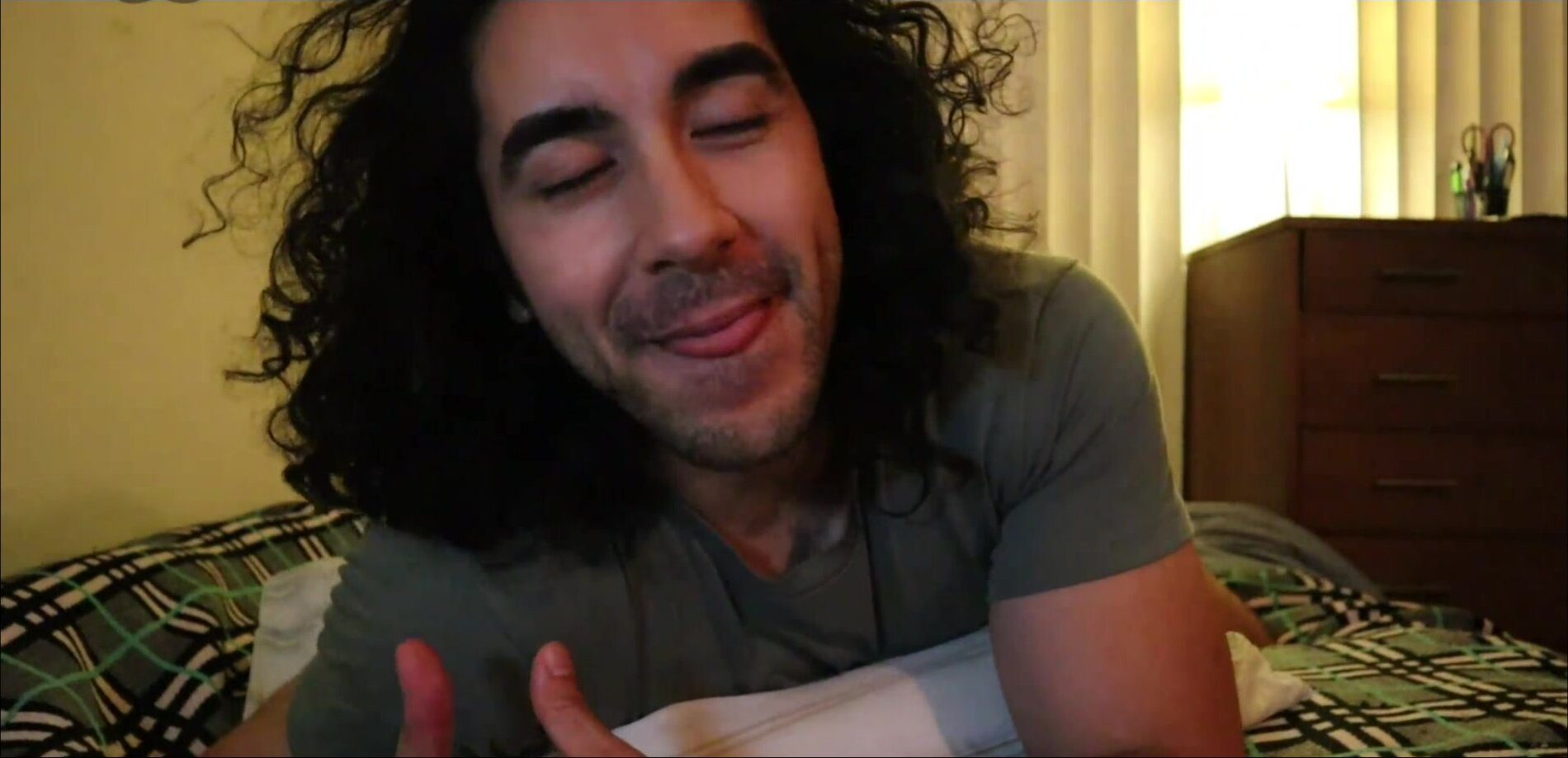 Long haired muscled man fucks a pillow