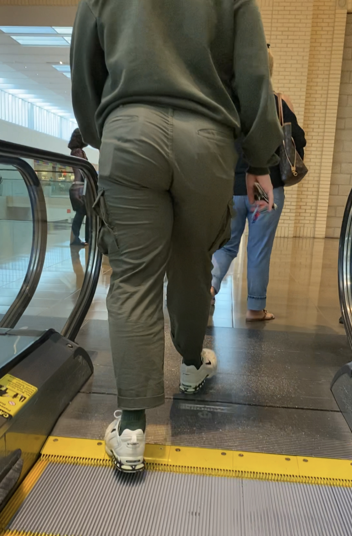 Super Beefy Guy Going Up The Escalator Then Strutting