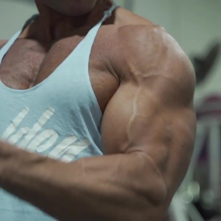 classic bodybuilder flexes massive arms, beatiful