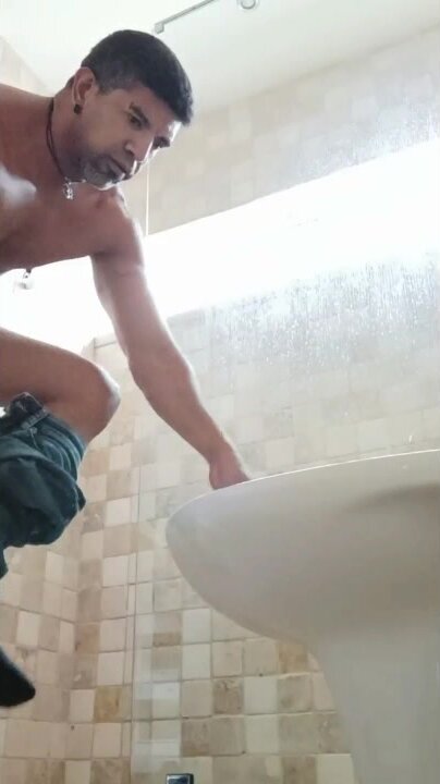 Muscle dude strips and licks toilet