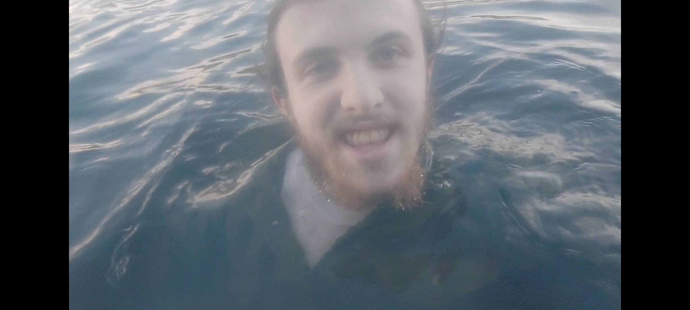 Swimming in a lake fully clothed