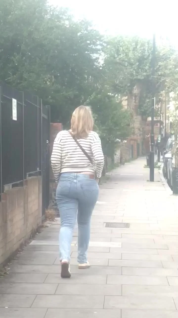 Sexy blonde milf walking in tight jeans photo photo