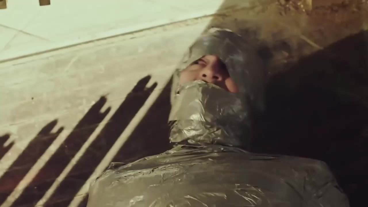 Man mummified in tape struggling