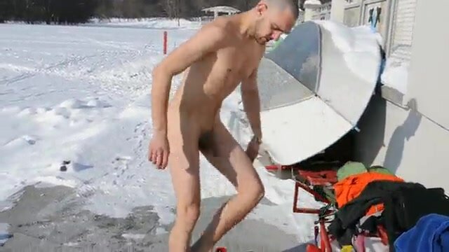 Cute guy dipping naked in ice cold water