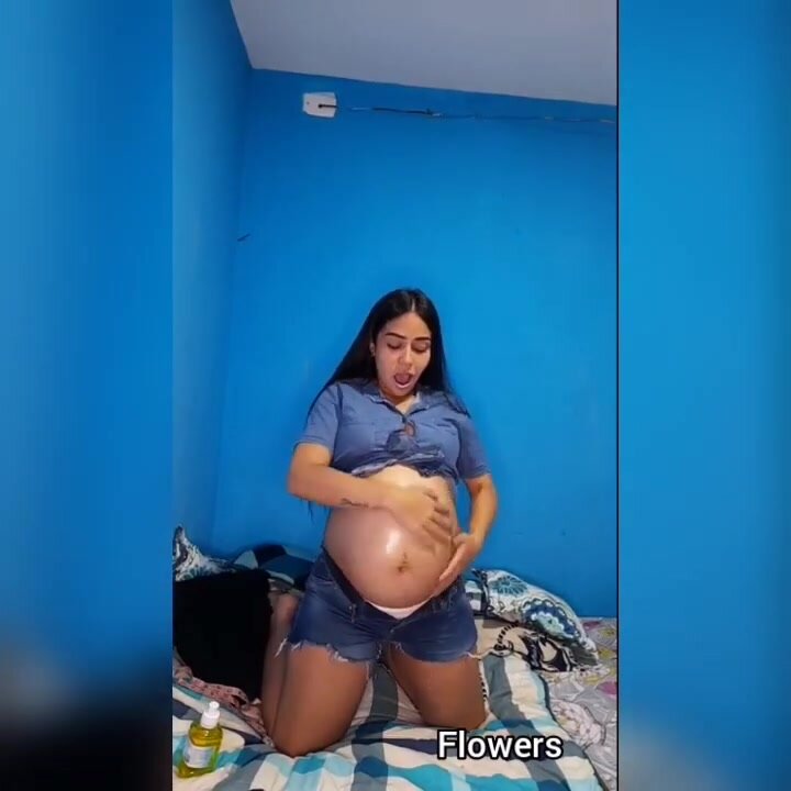 Chanel Latina rubs her belly