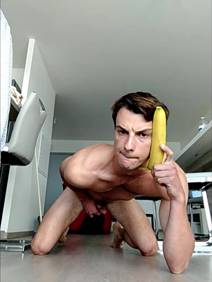 Sexy man sucks a banana while wanking