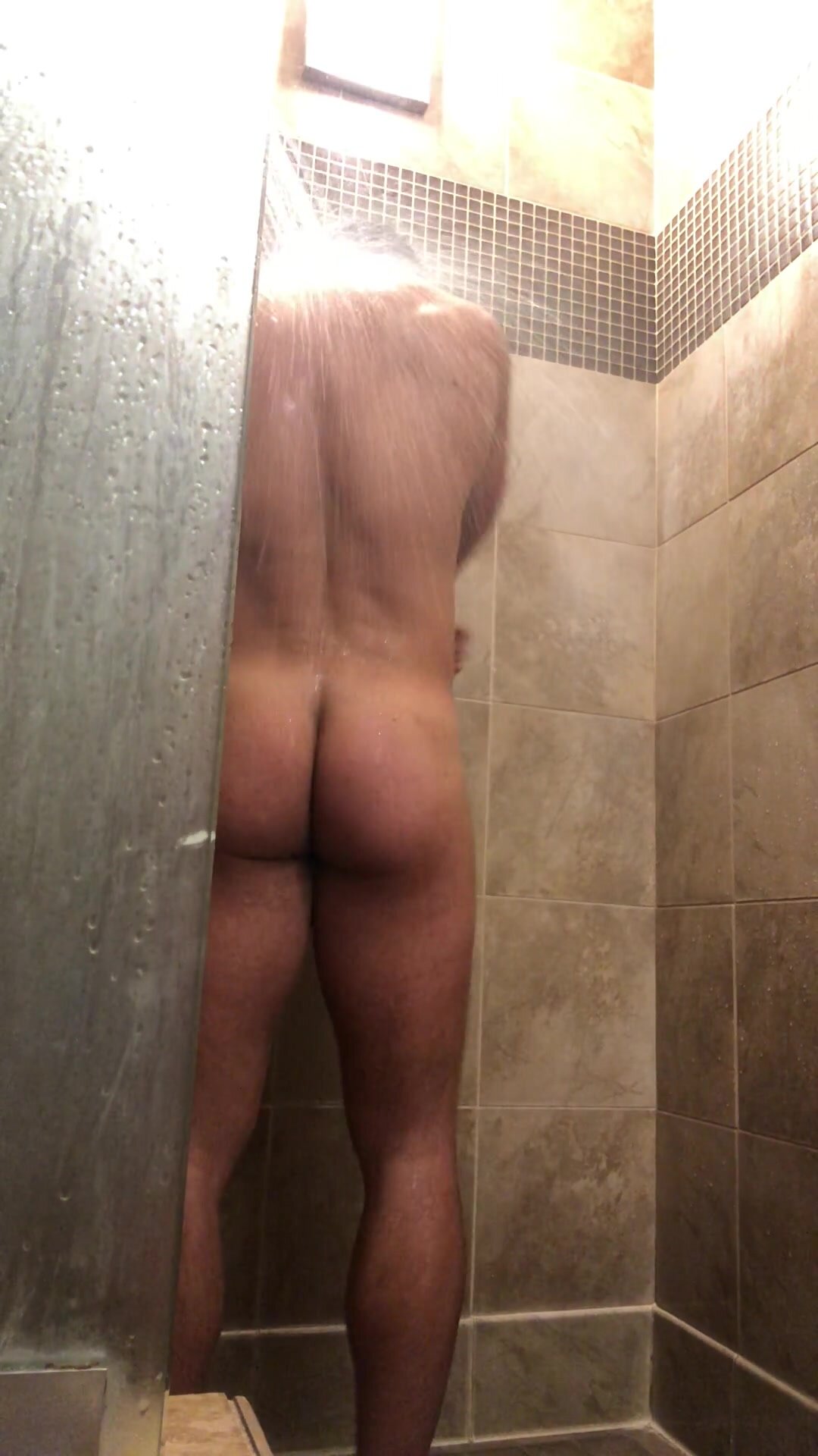 Beefy jock flexes in shower with boner