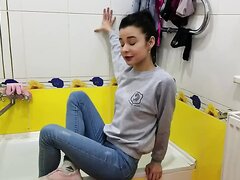 Girl wear jeans and fully clothes wetlook