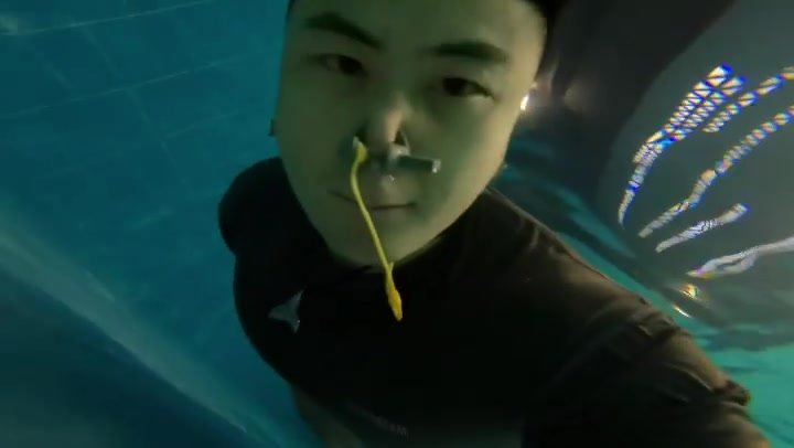 Underwater barefaced asian with noseclip