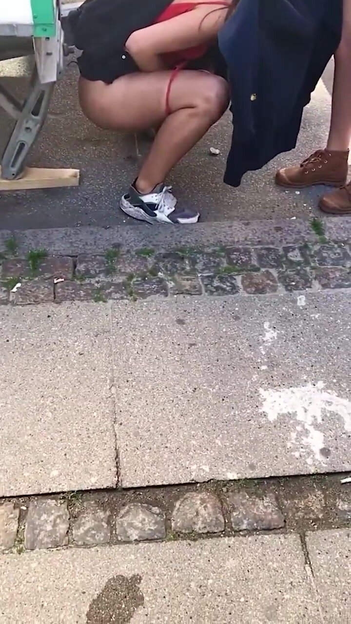 Girl tries to shield friend peeing