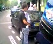 Pissing between cars in Paris.