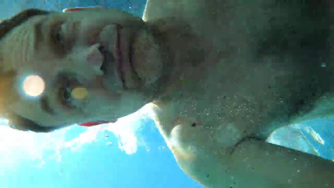 Barefaced daddy underwater in pool