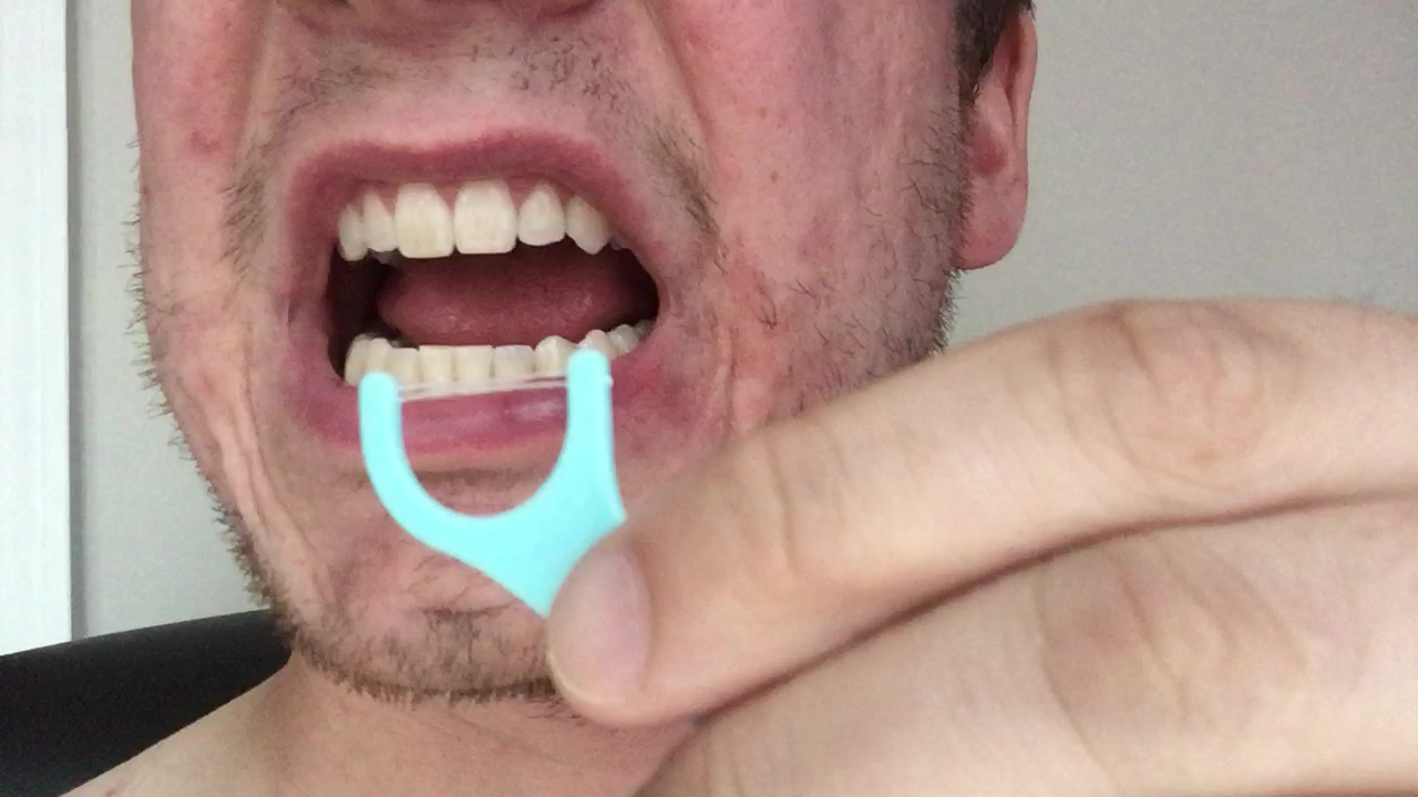 Straight White Teeth Getting Flossed After Lunch